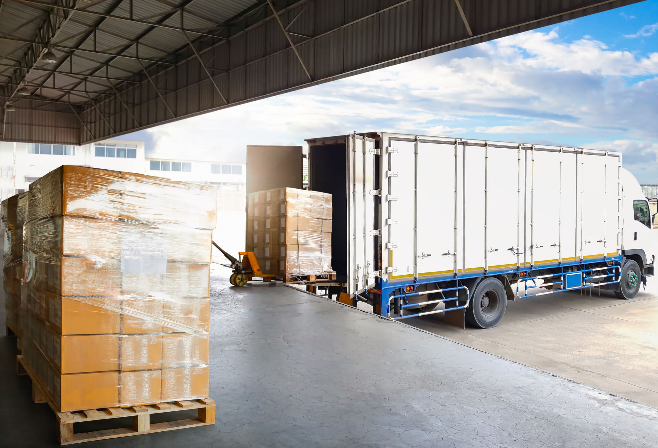 Container Trucks Parked Loading Package Boxes Pallets at Warehouse Dock. Supply Chain, Distribution Warehouse Shipping, Supplies Shipment Boxes. Freight Truck Logistic, Cargo Transport. Delivery collecting at a warehouse.