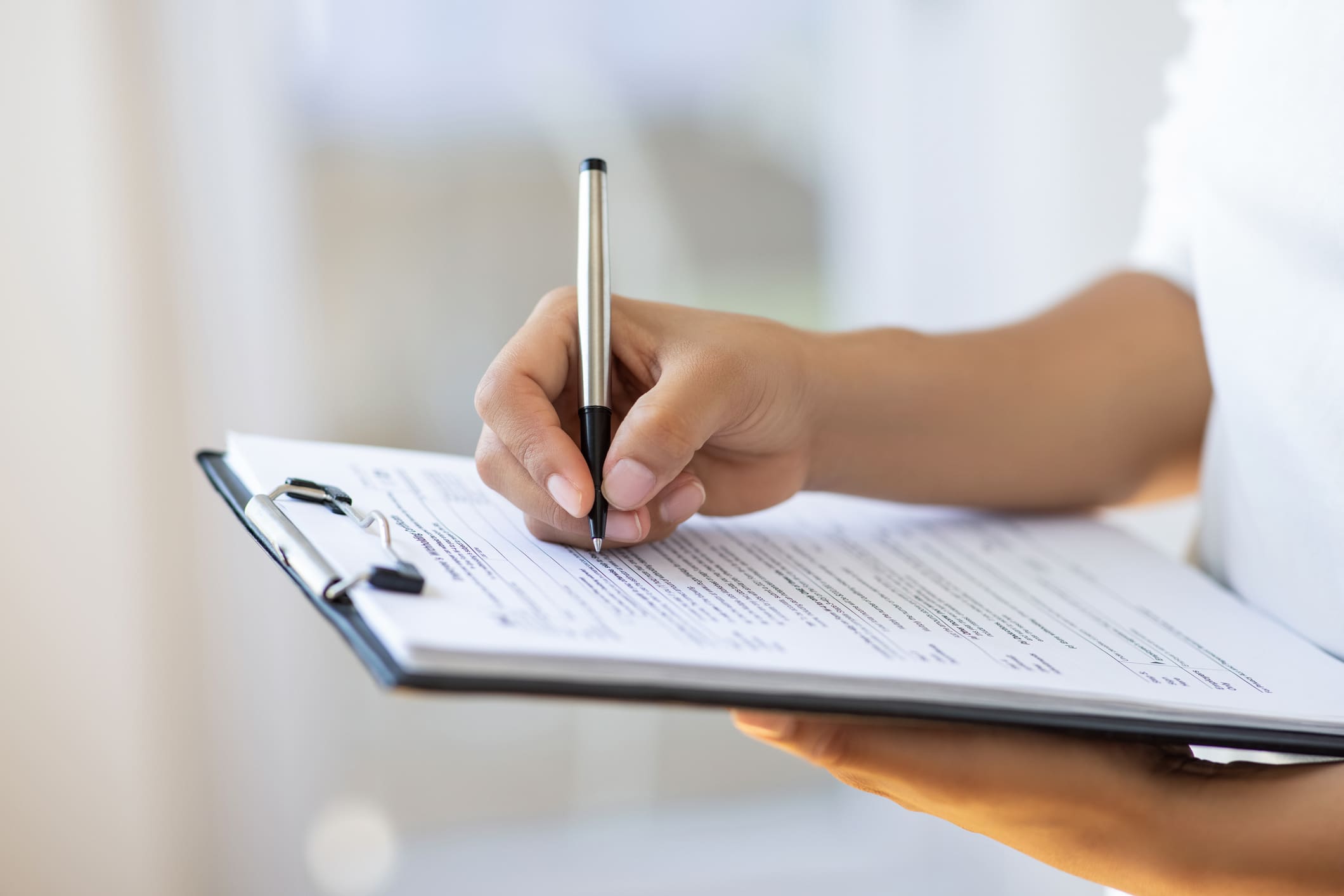 Holding clipboard and a pen in office All our products come with comprehensive documentation to maintain transparency and compliance throughout the supply chain.