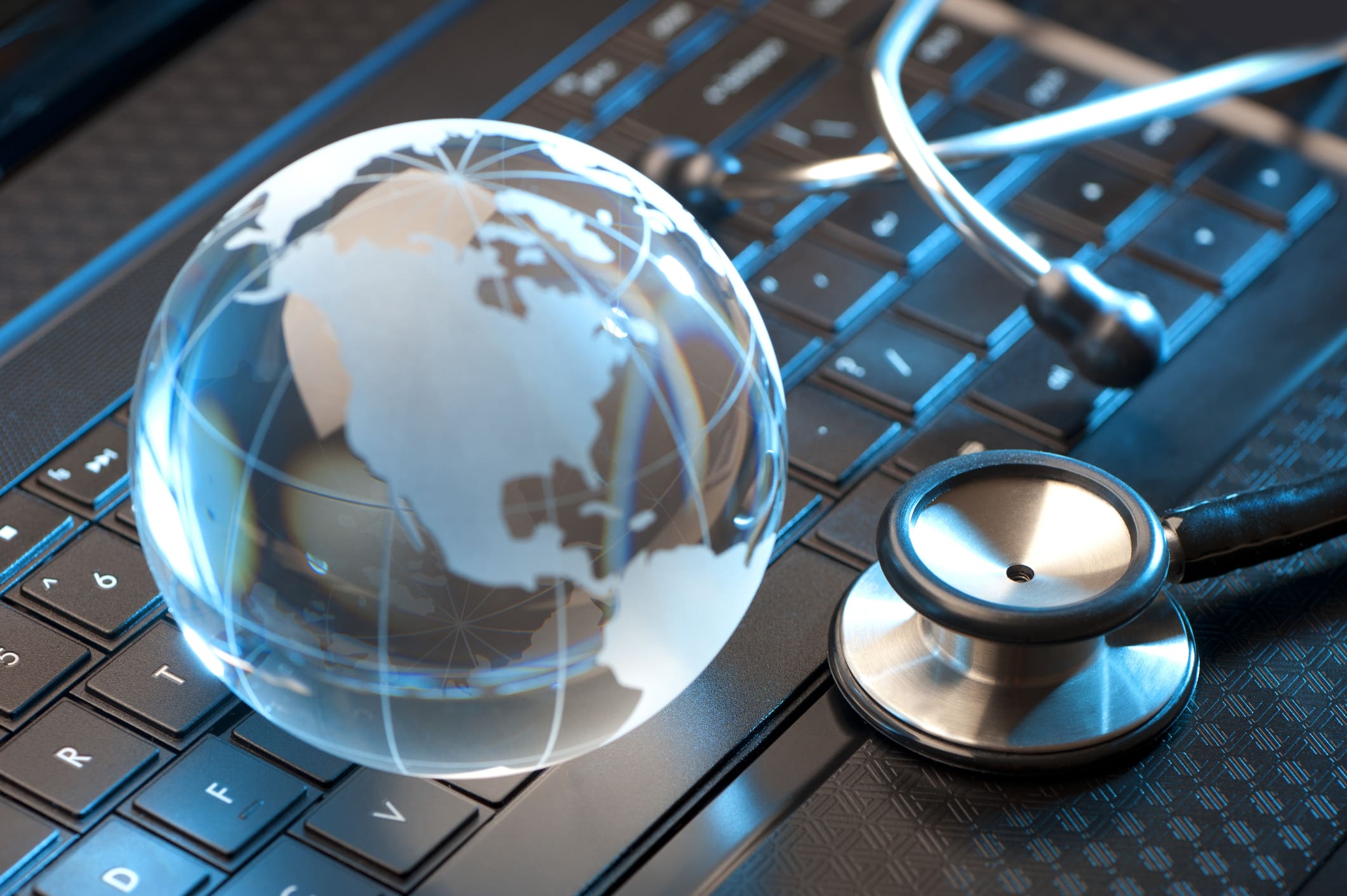 Stethoscope and globe on a laptop