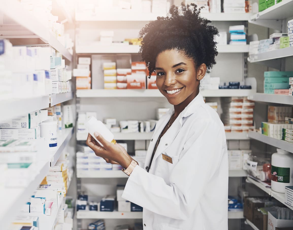 Black woman, portrait and pharmacist with product in clinic of medicine stock, reading and check information on label. Smile, female person and pills box for medical inventory, inspection and retail It makes me happy when we have what the customer needs